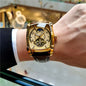 Alcom Distribution men's mechanical square watch with gold case and black leather strap on wrist