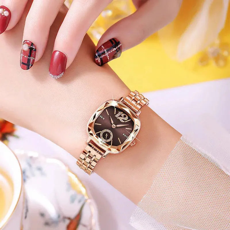 Alcom Distribution rose gold luxury women's watch with brown sunburst dial and geometric bezel on wrist