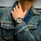 Alcom Distribution sustainable watches for men worn with denim jacket showing black strap and silver chronograph dial