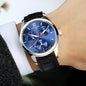 CARNIVAL men's automatic watch blue dial, silver case, black leather strap on wrist with dress shirt
