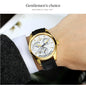 CARNIVAL men's automatic watch gold case white dial blue hands black leather strap on wrist by Alcom Distribution