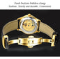 CARNIVAL men's automatic watch gold exhibition caseback showing movement with push button hidden clasp and black leather strap