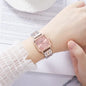 Square quartz watch for women with pink dial and silver bracelet on wrist by Alcom Distribution