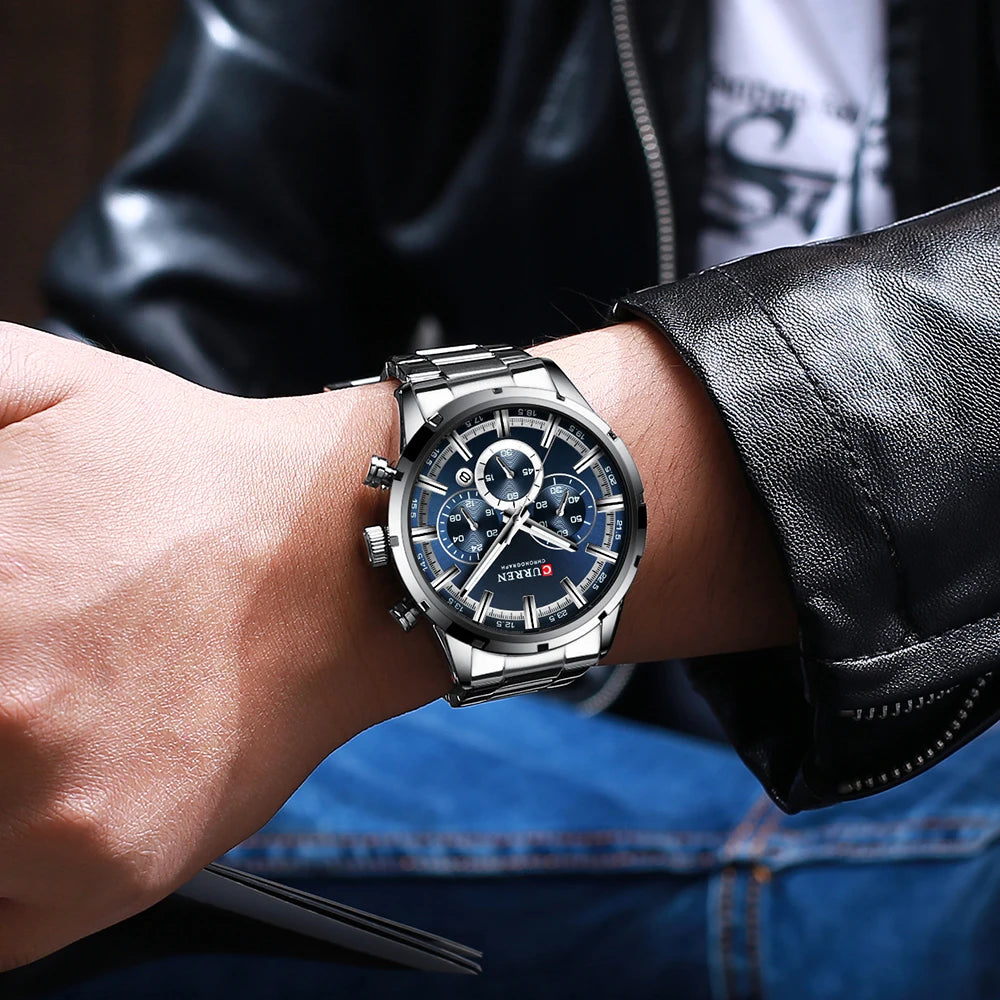 Curren luxury men's watch with silver stainless steel band and blue chronograph dial on wrist