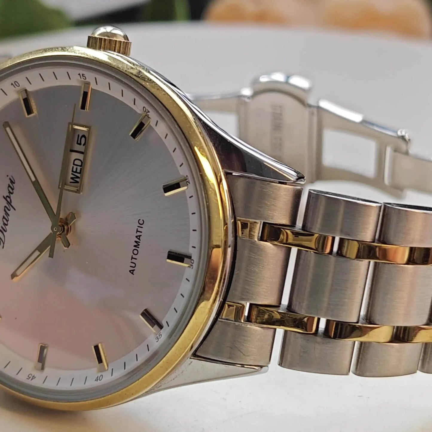 Alcom Distribution men's automatic business watch with gold and silver stainless steel band and date display