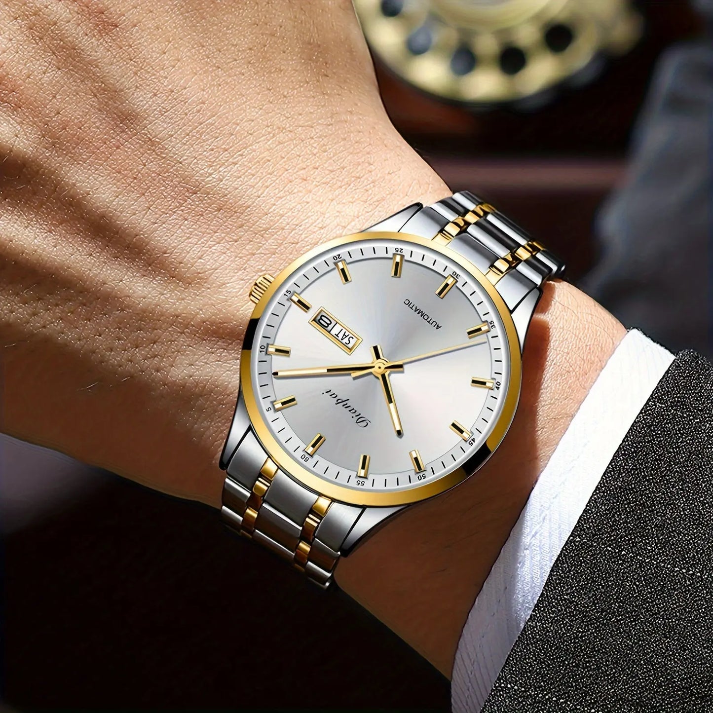 Alcom Distribution men's automatic business watch with silver and gold stainless steel band on wrist