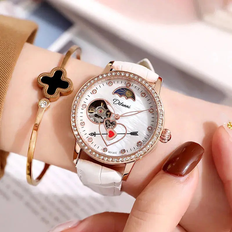 Women's luxury automatic watch with white leather strap and rose gold bezel accented with crystals