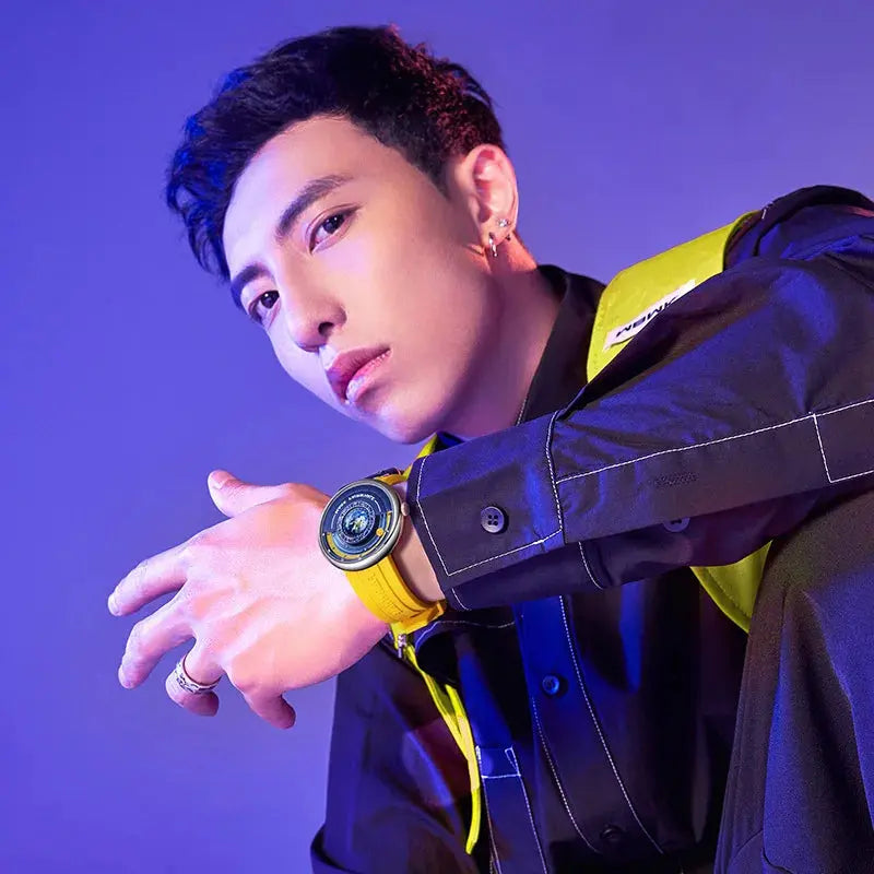 Alcom Distribution model wearing luxury quartz men's wristwatch with yellow strap and bold dial