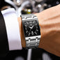 Alcom Distribution stainless steel rectangular watch on wrist with black dial and Roman numerals luxury men's quartz watch