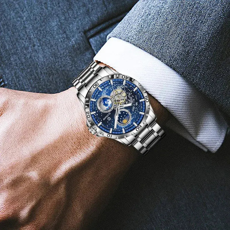 Glenaw rotating earth watch with blue dial and silver metal band on wrist in formal attire
