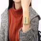 Alcom Distribution gold cuff quartz analog women's watch with rectangular face and crystal accents
