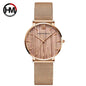 Hannah Martin rose gold watch with mesh band and minimalist wood-textured dial from Alcom Distribution