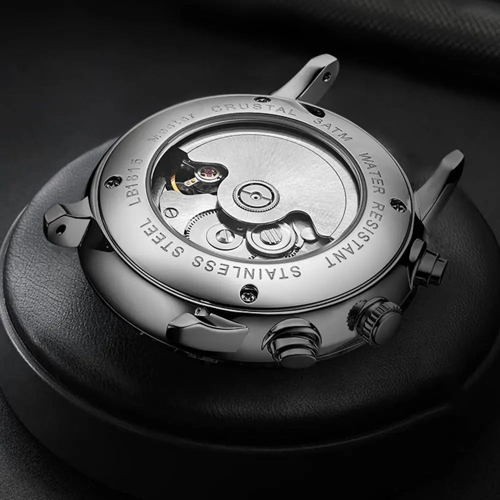 Luxury men's automatic watch back view showing stainless steel case and visible movement by Alcom Distribution