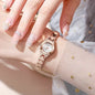 Alcom Distribution rose gold ladies bracelet watch on wrist with white dial linked bracelet and manicured nails