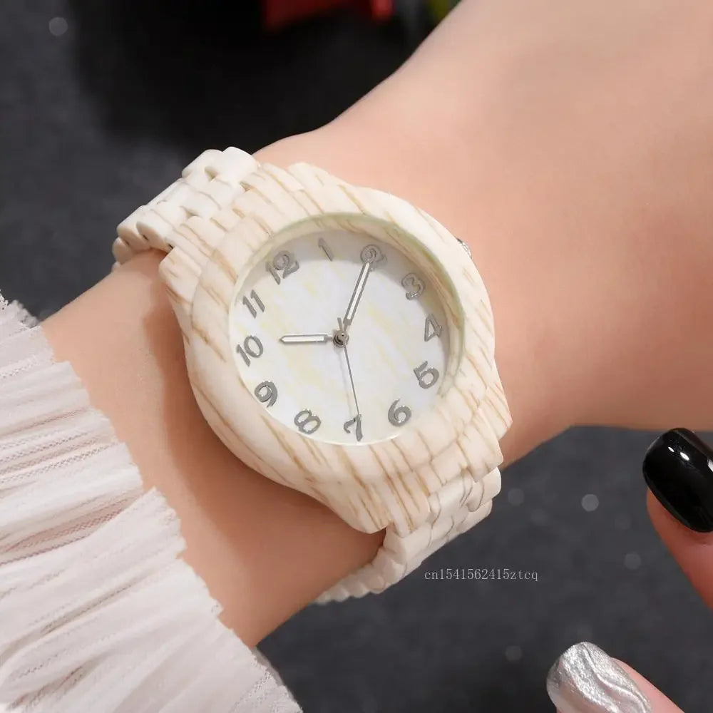 Luxury wood grain watch by Alcom Distribution with a white textured band on wrist