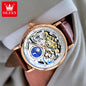 OLEVS luxury skeleton watch with gold case, brown leather strap, and intricate mechanical dial