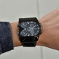 Alcom Distribution luxury multi time zone watch with black dial and leather strap on wrist