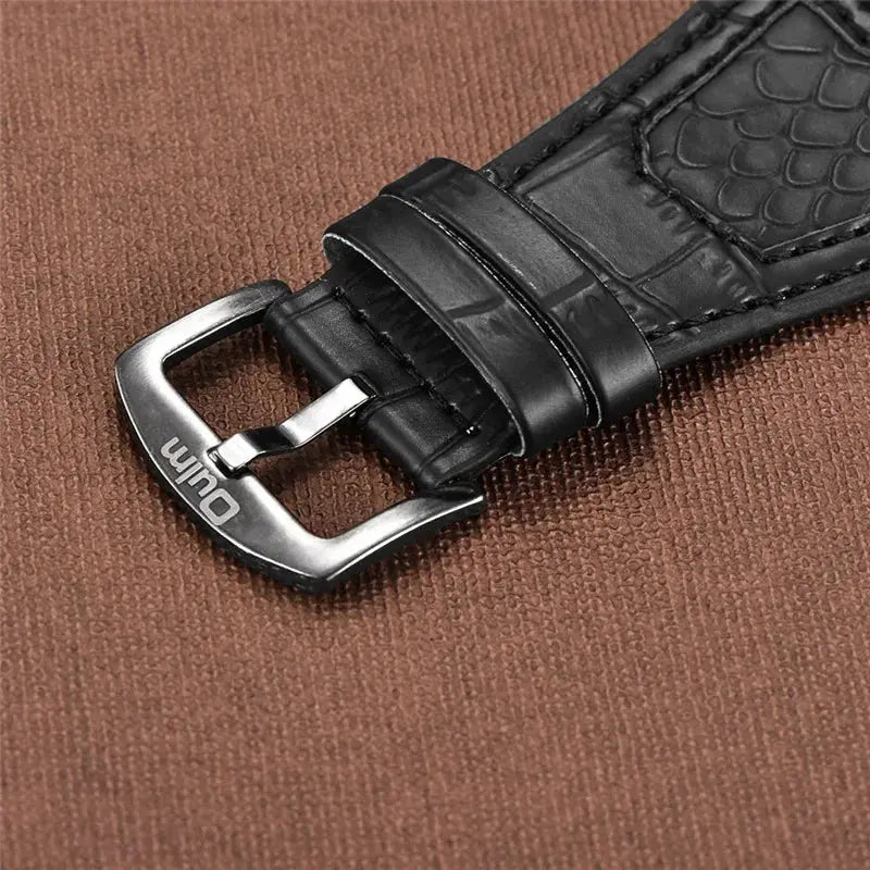 Alcom Distribution men's dual time wristwatch black croc leather strap with stainless steel buckle close up