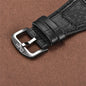 Alcom Distribution men's dual time wristwatch black croc leather strap with stainless steel buckle close up