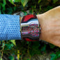 Alcom Distribution men's dual time wristwatch with red leather accents and stainless steel case on wrist