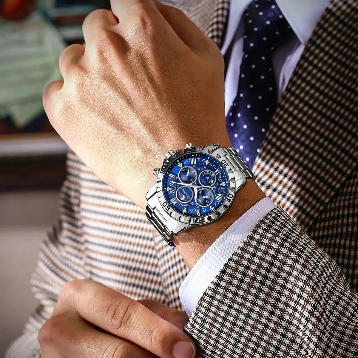 Fashionable men's luxury watch with blue dial and silver band worn with checked suit and polka dot tie
