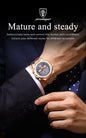Alcom Distribution men's quartz chronograph watch rose gold case and bracelet with blue dial on a suited wrist