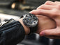 Timascus automatic watch on wrist with black strap and intricate dial design