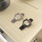 Alcom Distribution hello kitty diamond watch duo with silver and black mesh bands and pink crystal bow accents