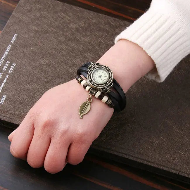 Shourui quartz wristwatch for women with leather strap and leaf charm on wrist