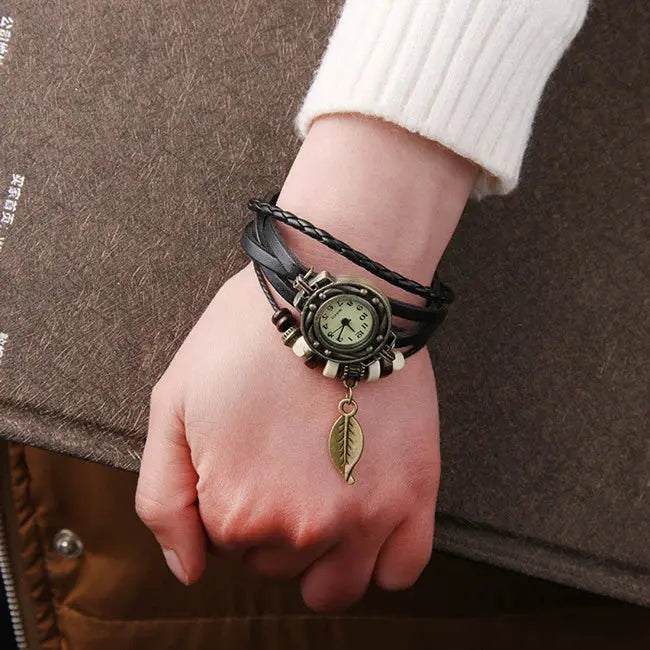 Shourui quartz wristwatch for women with a vintage round dial and black braided leather strap with leaf charm