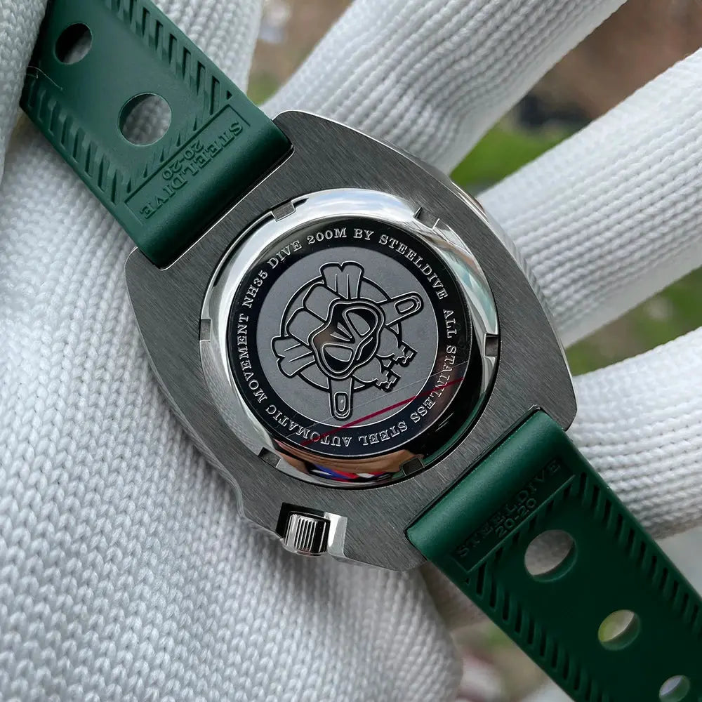 Back view of Steeldive SD1970 automatic dive watch showing stainless steel case back and green strap
