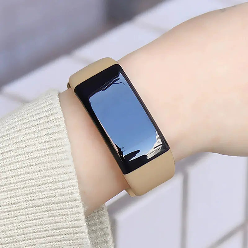 Alcom Distribution tech-savvy fitness wearable watch with beige band on wrist