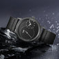 Minimalist men's leather watch with black dial and black leather strap by Alcom Distribution