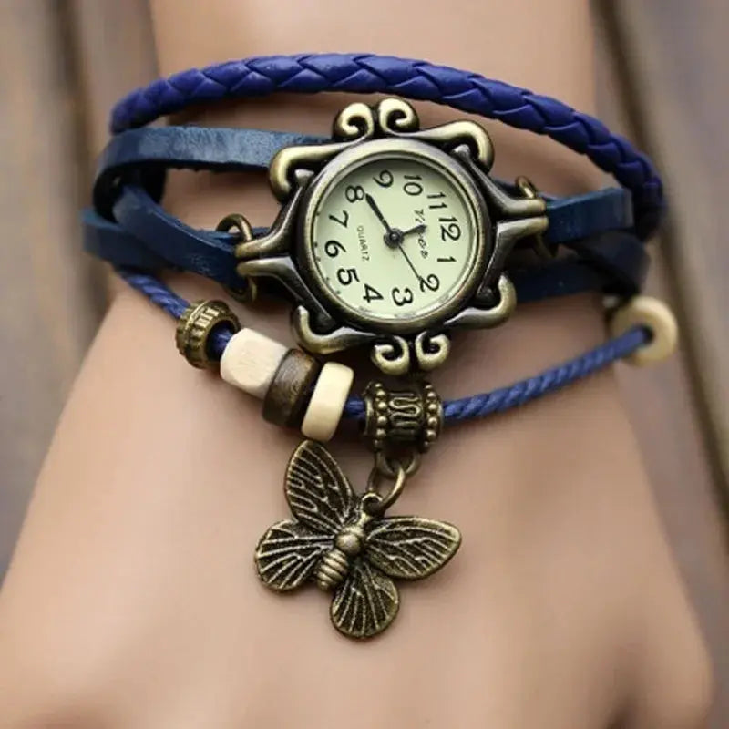 Vintage butterfly bracelet watch with blue leather straps and antique bronze charm by Alcom Distribution