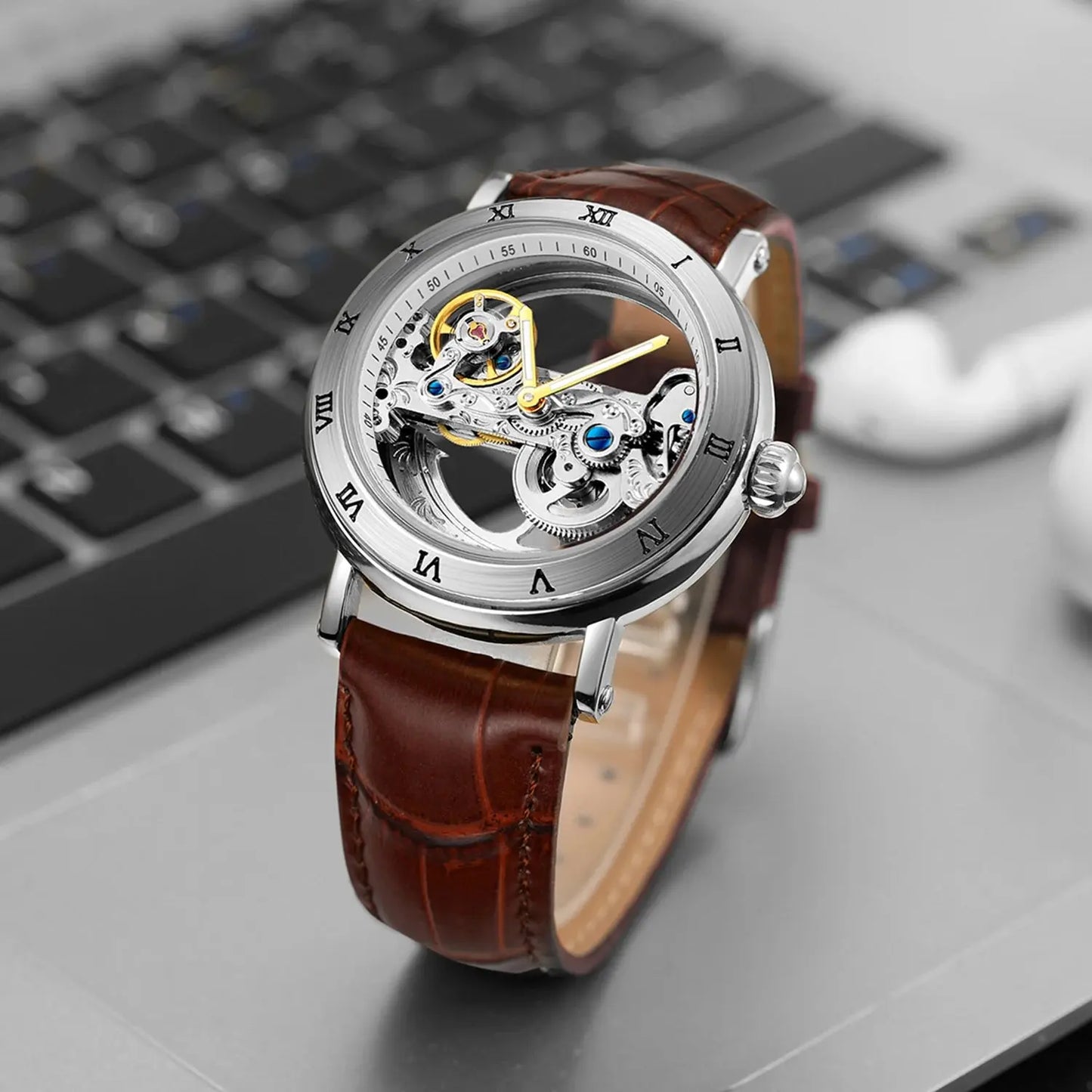 Alcom Distribution vintage golden skeleton watch with brown leather strap and silver case close-up