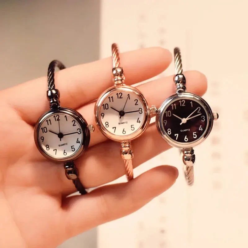 Alcom Distribution retro gold bangle watch with round dial and twisted metal band in black silver and rose gold