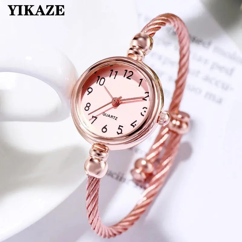 Retro gold bangle watch with pink dial and twisted metal band by Alcom Distribution