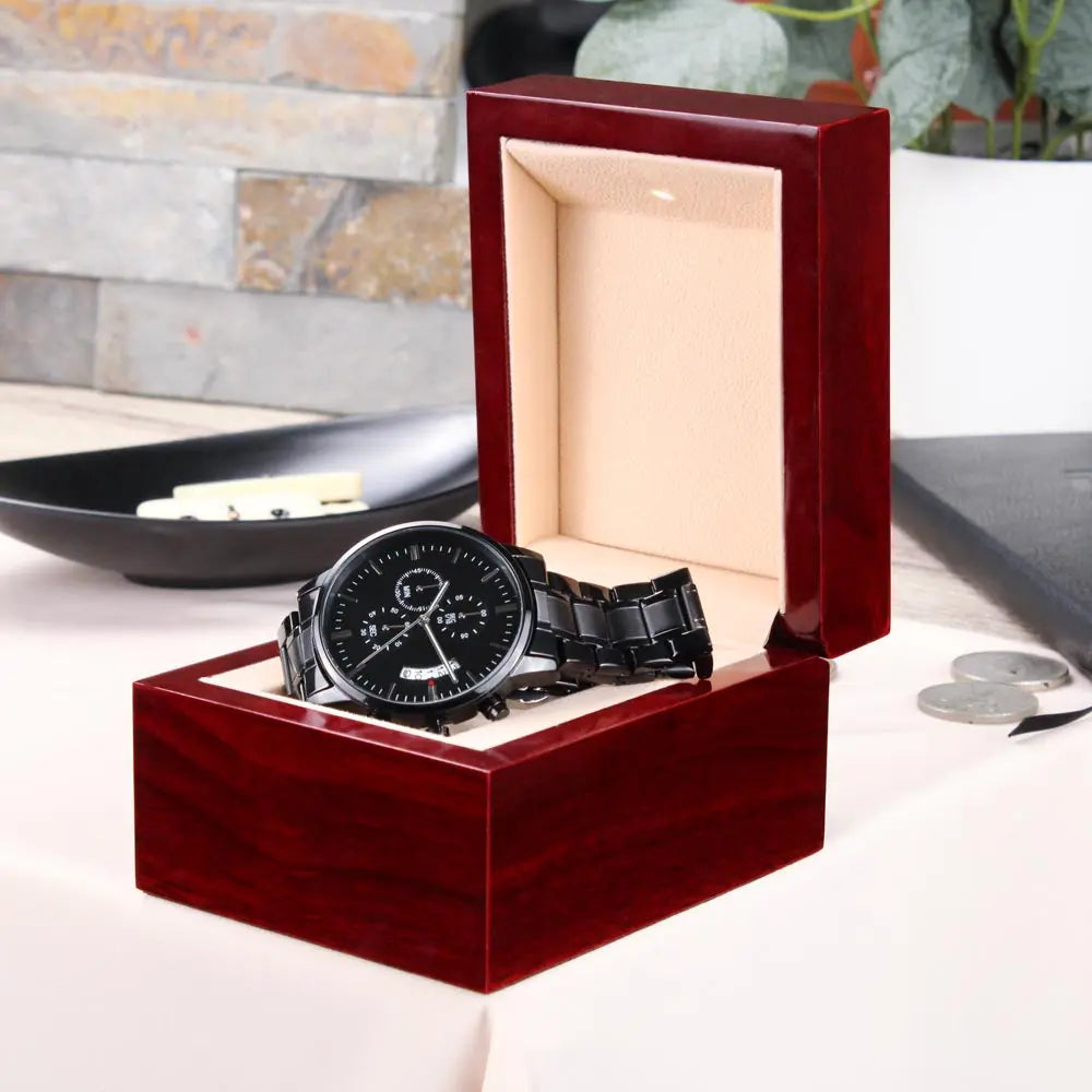Black chronograph watch gift for husband displayed in a polished wooden box