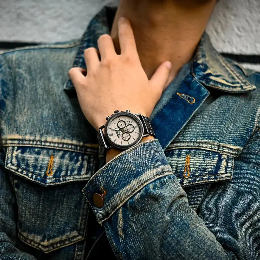 Alcom Distribution sustainable watches for men worn with denim jacket showing black strap and silver chronograph dial