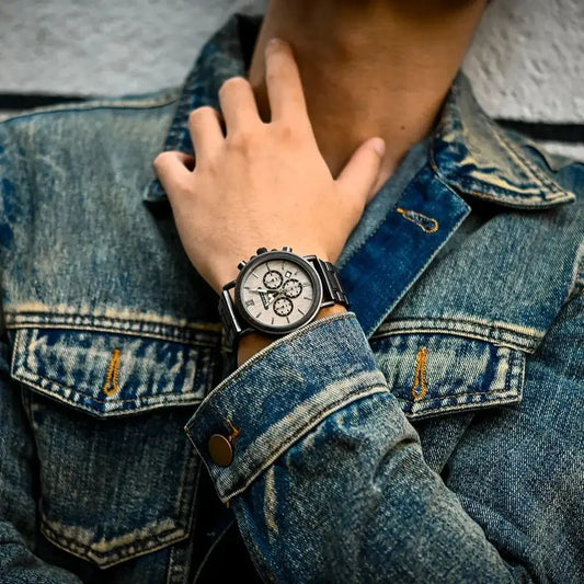Alcom Distribution sustainable watches for men worn with denim jacket showing black strap and silver chronograph dial