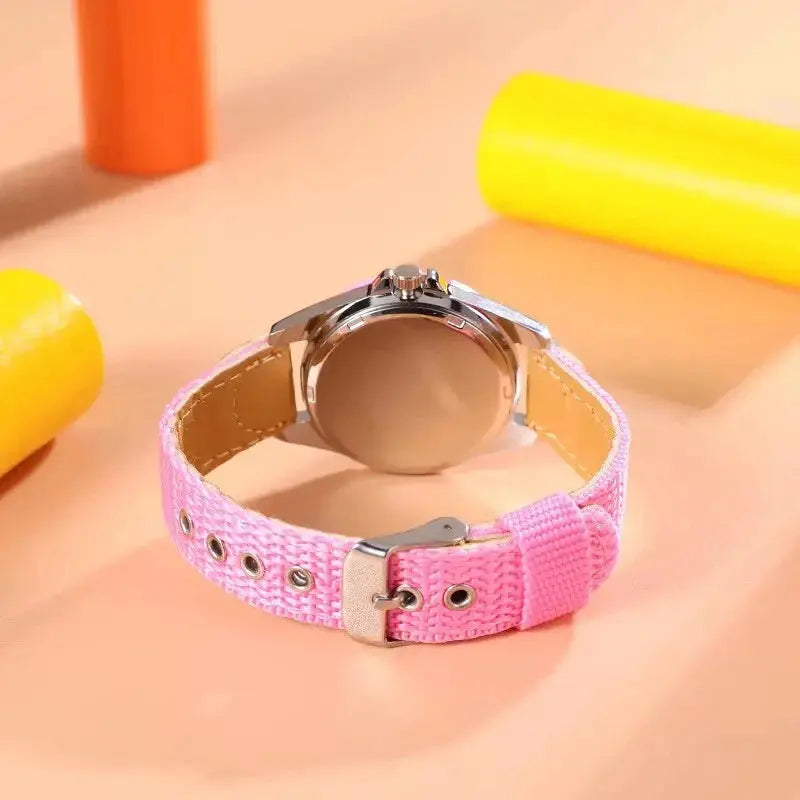 Alcom Distribution kids quartz watch colorful with pink fabric strap and silver buckle on peach background
