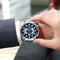 CURREN sport chronograph watch on wrist with blue dial and stainless steel band for stylish functionality