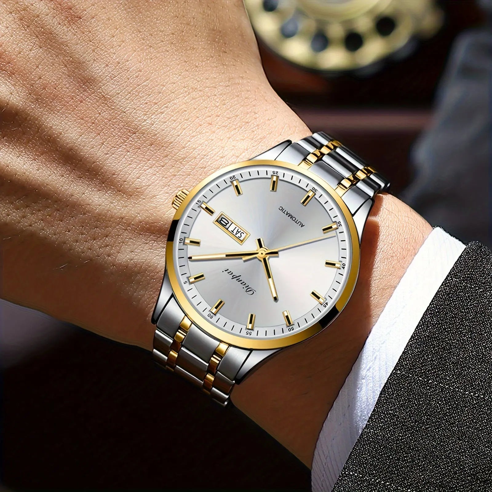 Alcom Distribution men's automatic business watch with silver and gold stainless steel band on wrist
