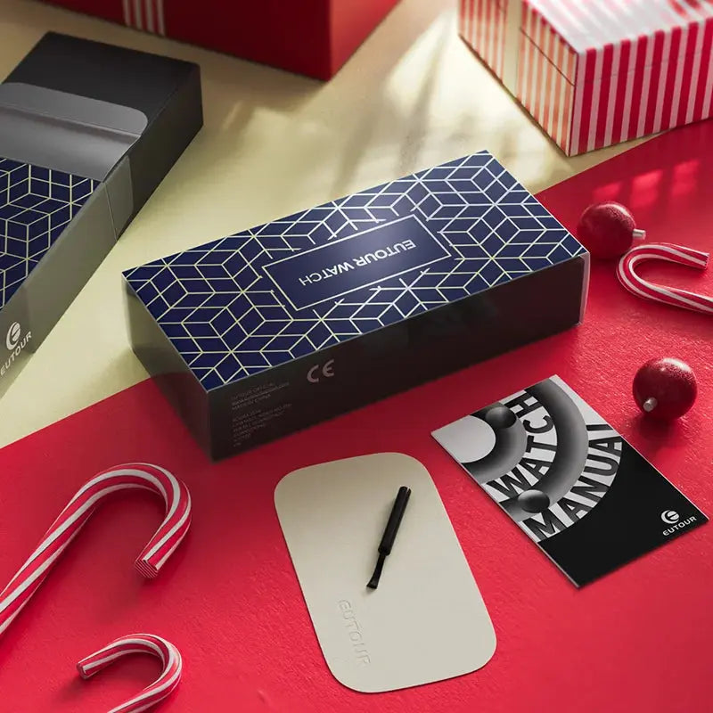 Stylish Magnetic Bead Watch packaging by Alcom Distribution with user manual and black tool on red surface