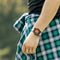 Stylish Magnetic Bead Watch on wrist with black and wooden dial and white strap by Alcom Distribution