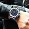 Alcom Distribution waterproof dual display watch with silver case and blue dial on wrist