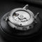 Luxury men's automatic watch back view showing stainless steel case and visible movement by Alcom Distribution