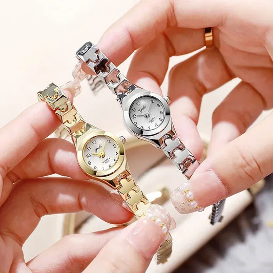Alcom Distribution rose gold ladies bracelet watch held with matching silver bracelet watch showing round dial