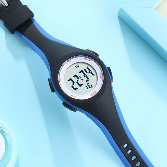 Alcom Distribution kids sport digital watch with blue and black strap on light blue background