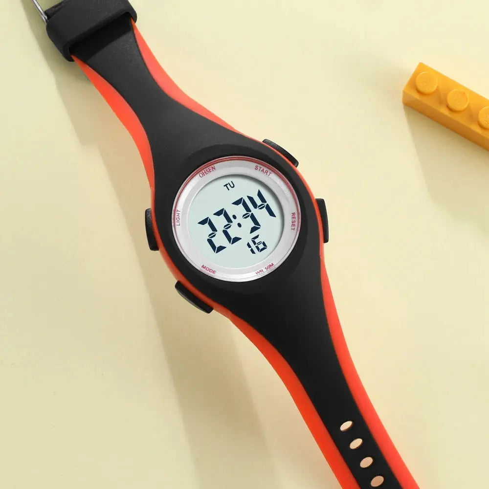 Alcom Distribution kids sport digital watch with black and orange strap showing digital time display
